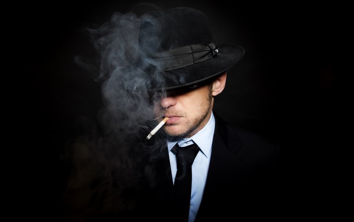 Man in fedora smoking a cigarette