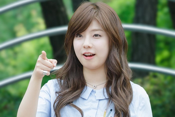 Korean girl group member pointing forward