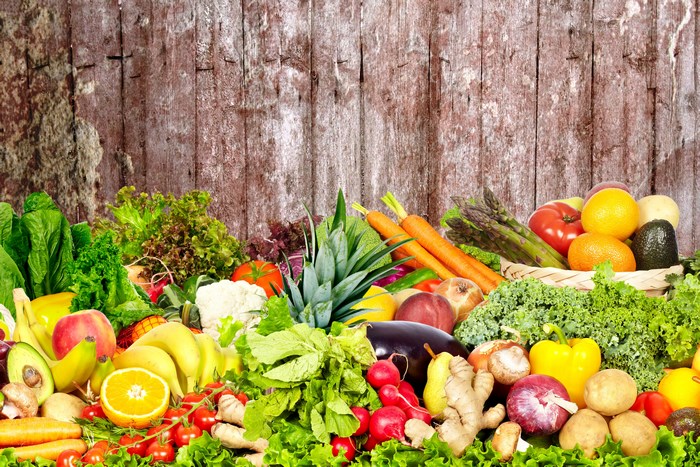 Assortment of Fresh Fruits and Vegetables on Wooden Background