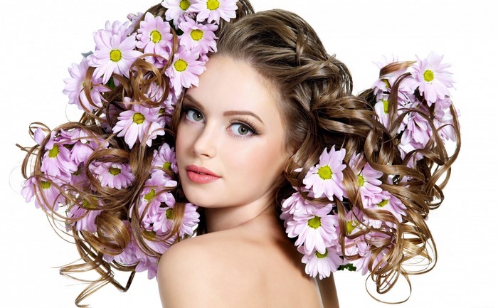 Woman with Curly Hair Adorned with Pink Flowers