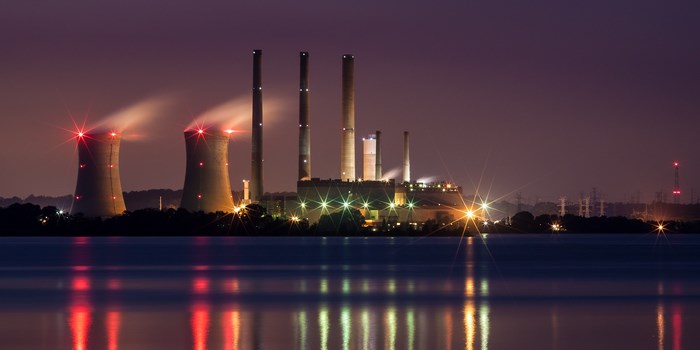 Power plant cooling towers and smokestacks at night