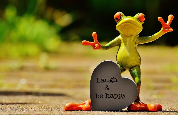 Frog figurine holding a heart with text