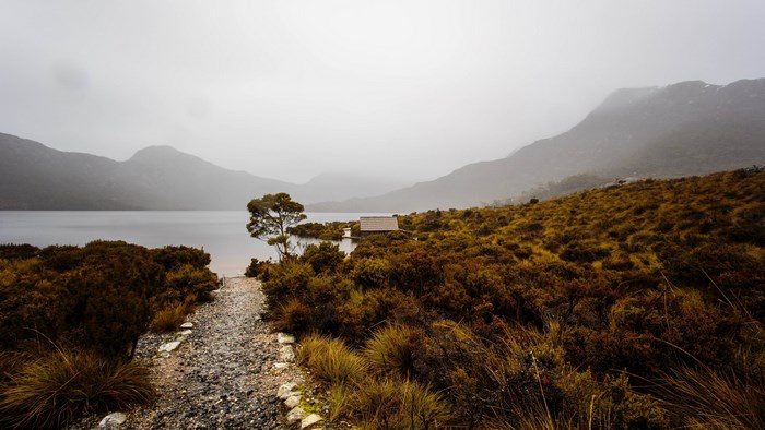 Lake and mountains with a small hut