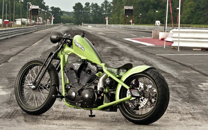 Custom lime green motorcycle on a drag strip