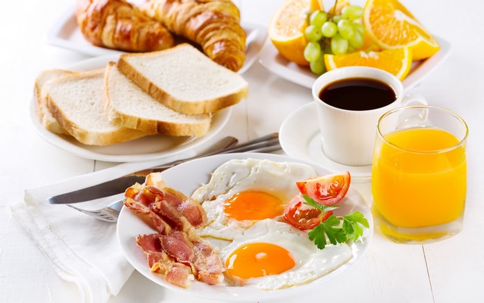 Classic Breakfast with Eggs, Bacon, and Fresh Juice