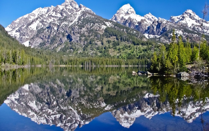 Snow-capped mountains reflected in a lake