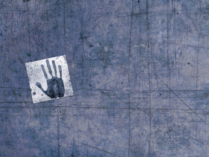 Handprint on a scratched blue surface