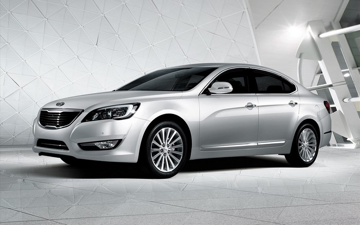 Silver Kia K9 sedan parked indoors