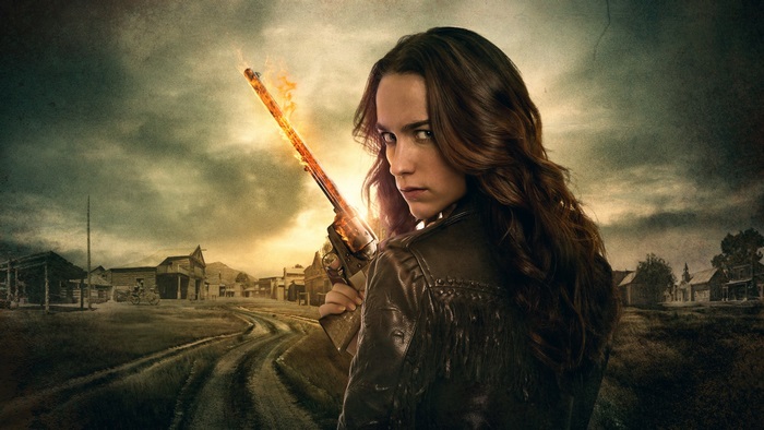 Melanie Scrofano with flaming rifle in Western town