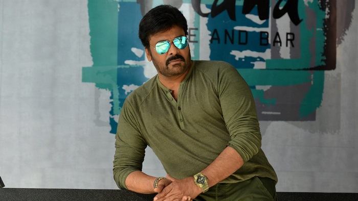 Chiranjeevi wearing sunglasses and green shirt