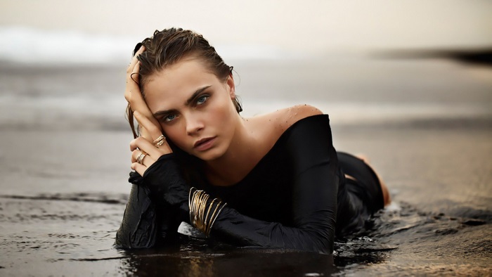 Cara Delevingne lying in shallow water