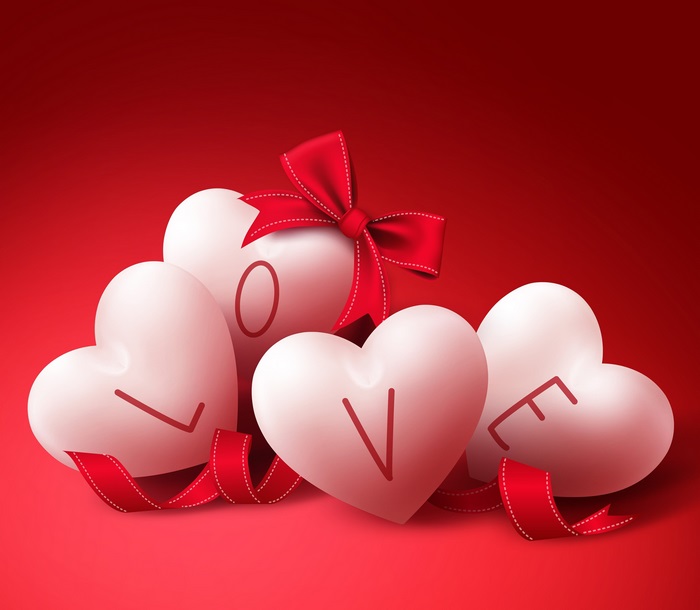 Four white hearts spelling LOVE with red ribbon