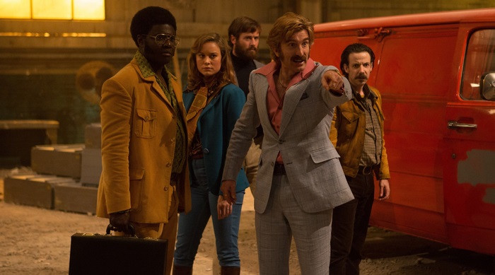 Group of people in retro clothing near a red van