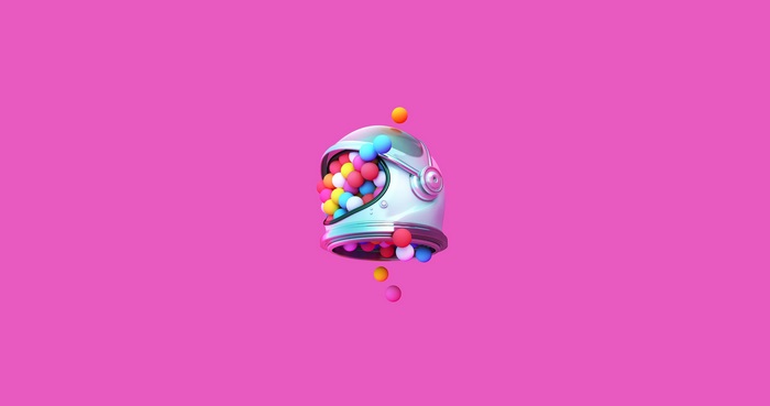 Astronaut helmet filled with colorful gumballs on pink background 4K