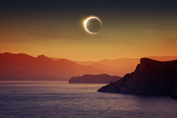 Solar eclipse over mountains and sea 4K