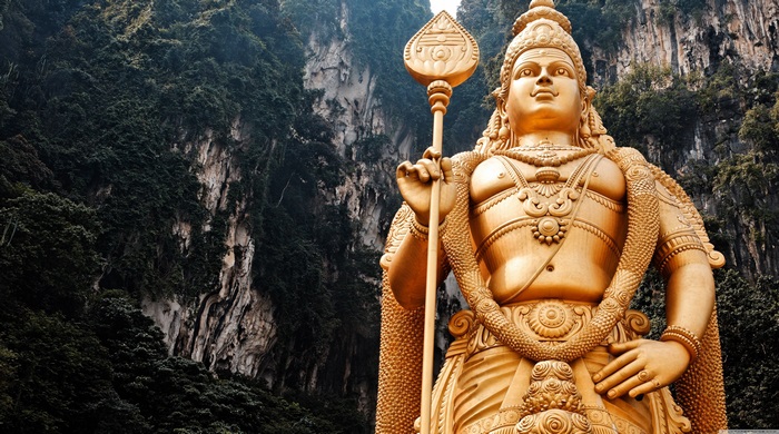 4K Statue of Lord Murugan Against Rocky Cliff