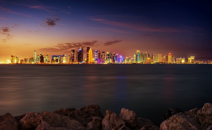 Doha skyline at dusk with ocean in foreground