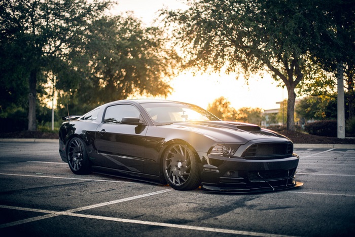 Black Ford Mustang in Parking Lot at Sunset