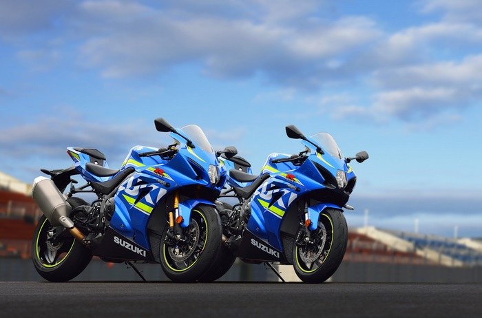Two blue Suzuki GSX-R1000 motorcycles on a track