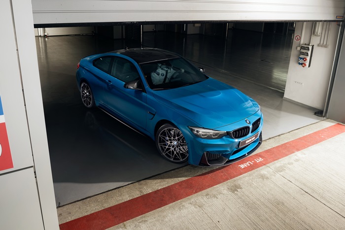 Blue BMW M4 Coupe Competition in a garage