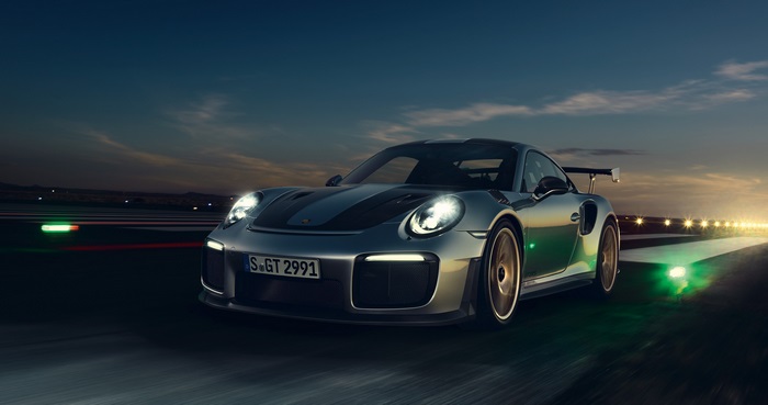 Porsche 911 GT2 RS on a track at dusk