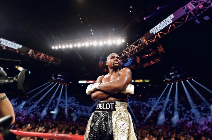 Floyd Mayweather in boxing ring with "Mayweather Pacquiao" banner