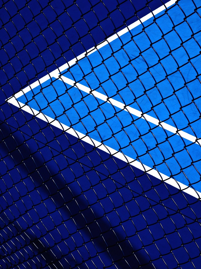 Tennis court with chain-link fence