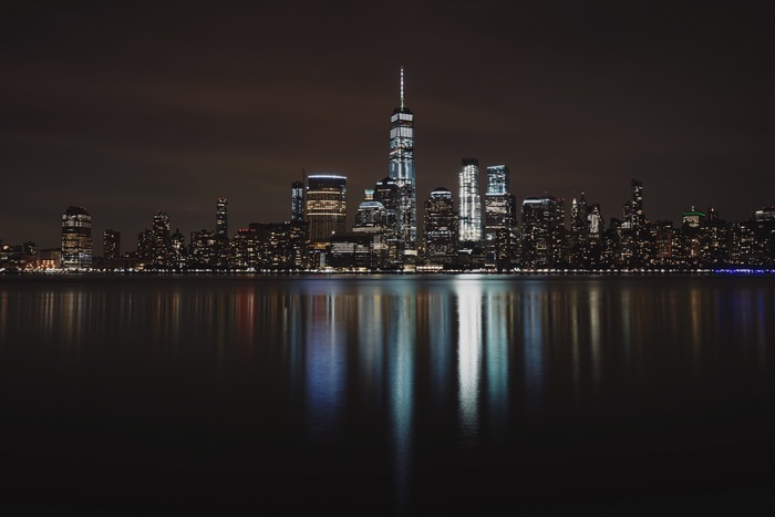 New York City skyline at night with reflections