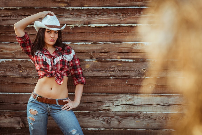 Cowgirl in a plaid shirt and jeans