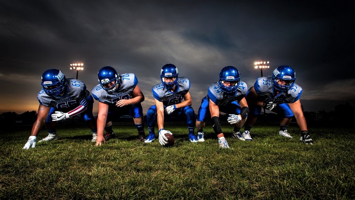 Football players in uniform on field