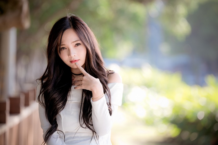 Asian woman in white top outdoors