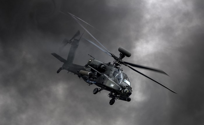 Boeing AH-64D Apache military helicopter in clouds