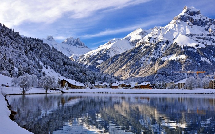 Snowy mountain landscape with a lake and village