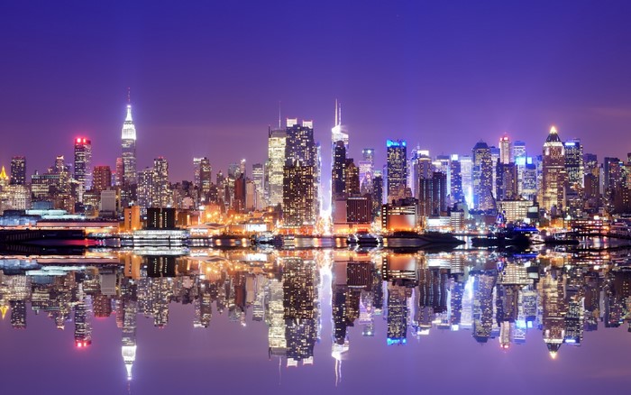 New York City skyline at night with reflections