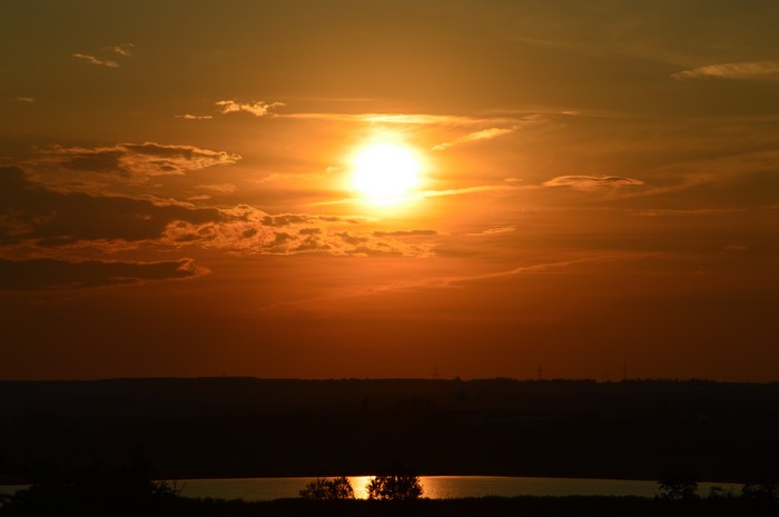 Sunset over a landscape with a lake