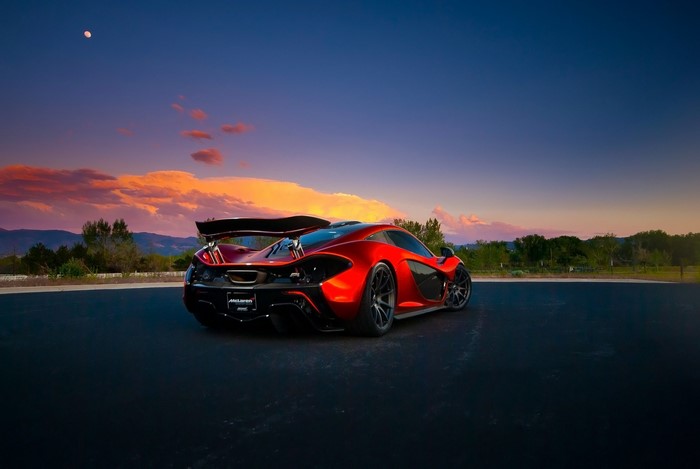 Red McLaren P1 sports car at sunset