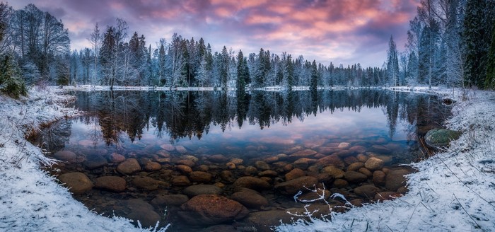 Winter Sunrise Over Snowy Forest Lake in Finland