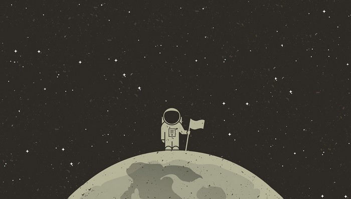 Astronaut standing on the moon with a flag