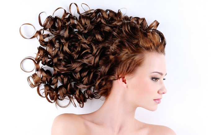 Woman with long curly brown hair
