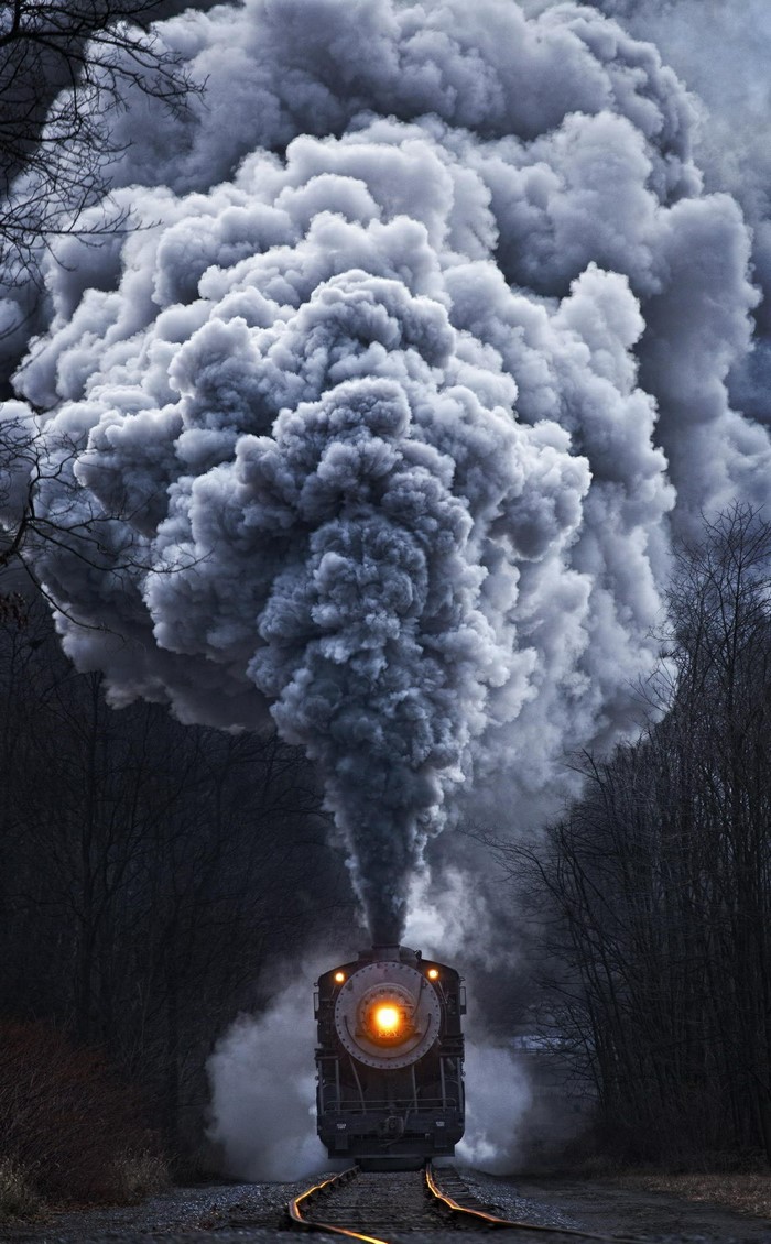 Steam train emitting large plume of smoke
