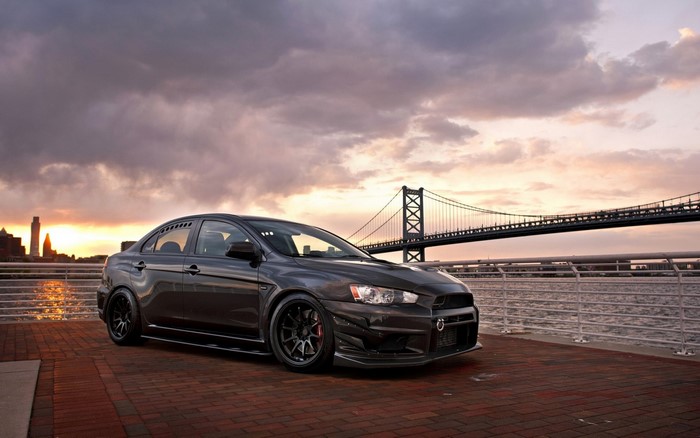Mitsubishi Lancer Evo X by a bridge at sunset