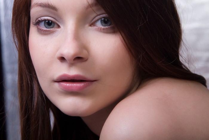 Close-up of a woman with blue eyes and brown hair