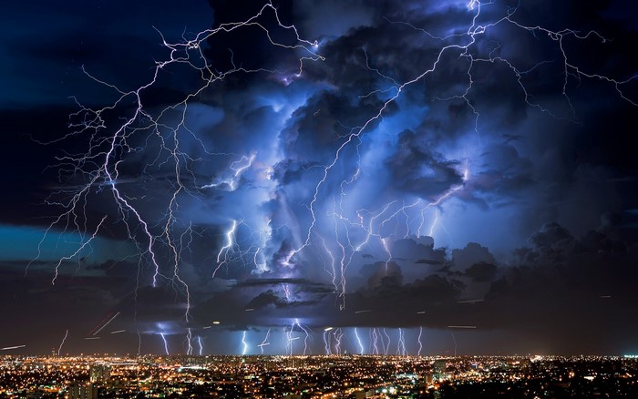 Lightning storm over a city at night