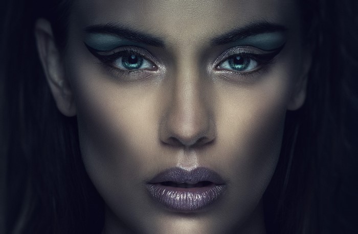 Woman with dramatic makeup and blue eyeshadow