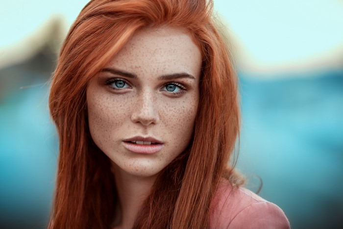 Woman with red hair and blue eyes with freckles