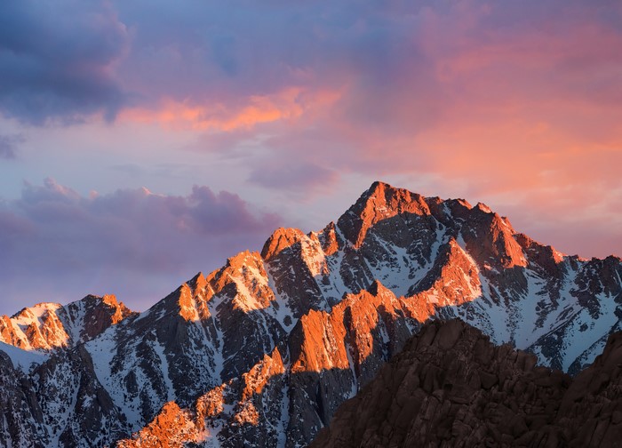 Mountain range at sunset with colorful clouds