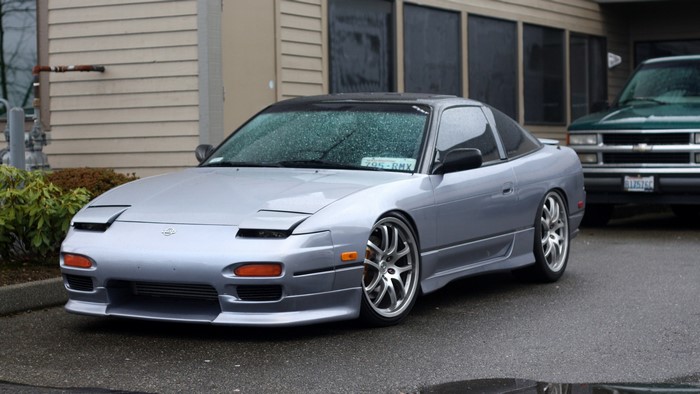 Silver Nissan 240SX parked outside building