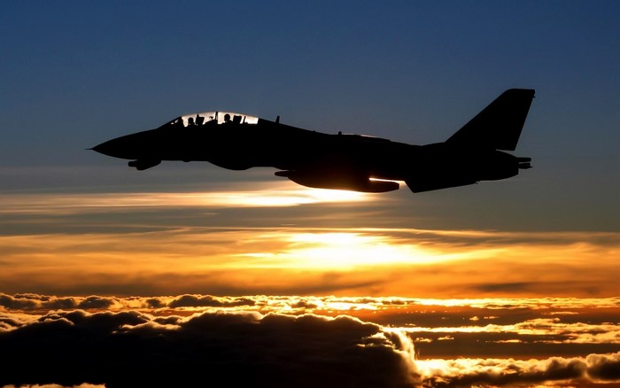F-14 Tomcat flying at sunset