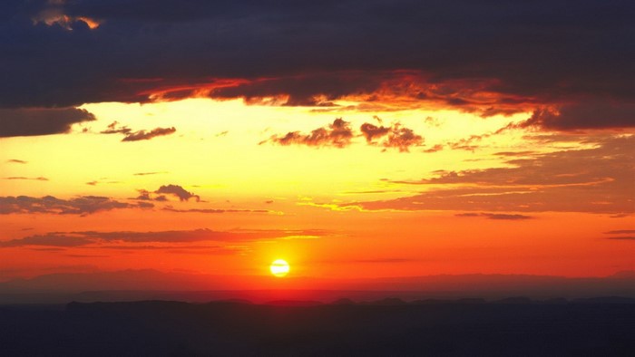 Sunset over mountains with dramatic clouds