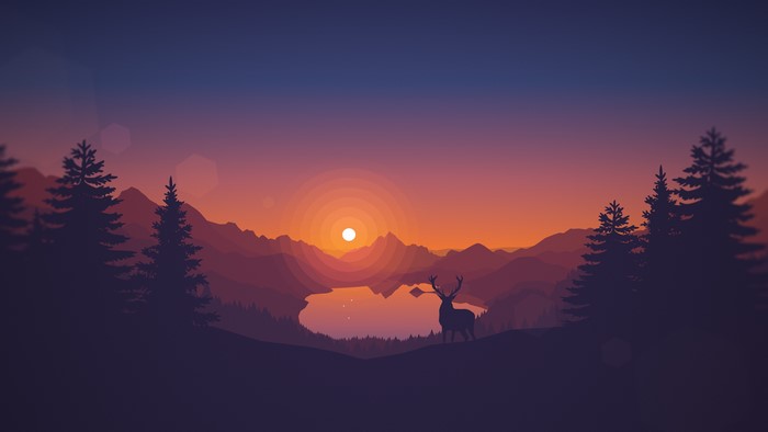 Deer by a lake at sunset with mountains and pine trees